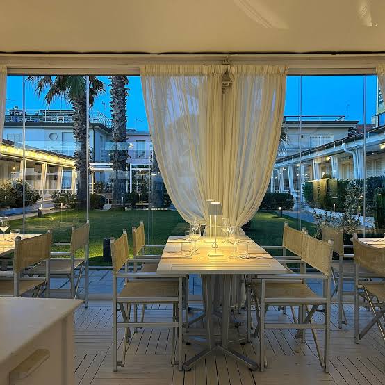 Sala luminosa del Ristorante La Pia con tavoli e apertura verso la spiaggia